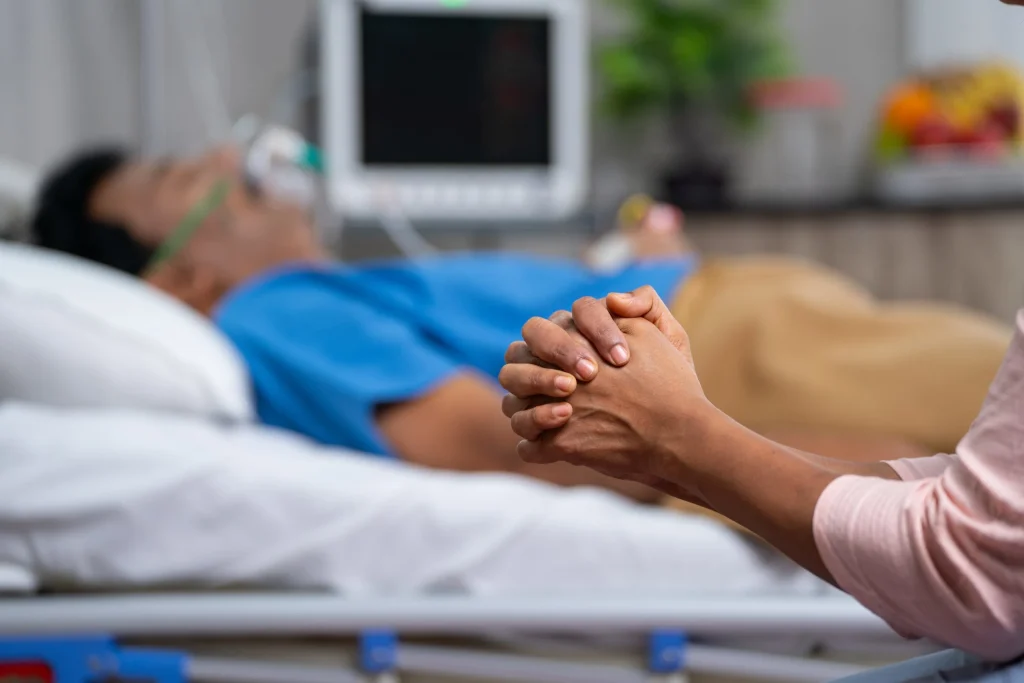 man-lying-in-hospital-bed-with-O2-1-scaled